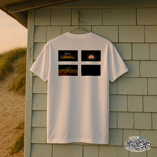 White t-shirt with cornish flag design, sun, surfer and 'This is Cornwall' text on a wooden shed background